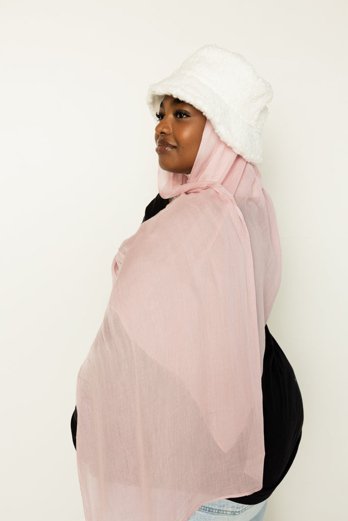 woman wearing modal hijab in different sizes in a light pink shade