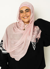 woman wearing modal hijab in different sizes in a light pink shade