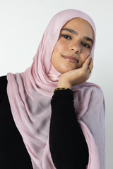 woman wearing modal hijab in different sizes in a light pink shade