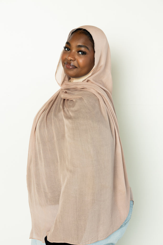 woman wearing modal hijab in different sizes in a truffle mushroom light sand stone tan shade