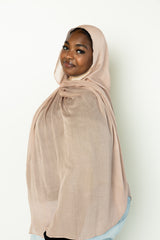 woman wearing modal hijab in different sizes in a truffle mushroom light sand stone tan shade