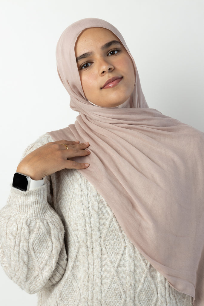 woman wearing modal hijab in different sizes in a truffle mushroom light sand stone tan shade