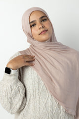 woman wearing modal hijab in different sizes in a truffle mushroom light sand stone tan shade