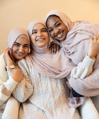 three women in a group photo wearing modal hijab in different sizes in a truffle mushroom light sand stone tan shade