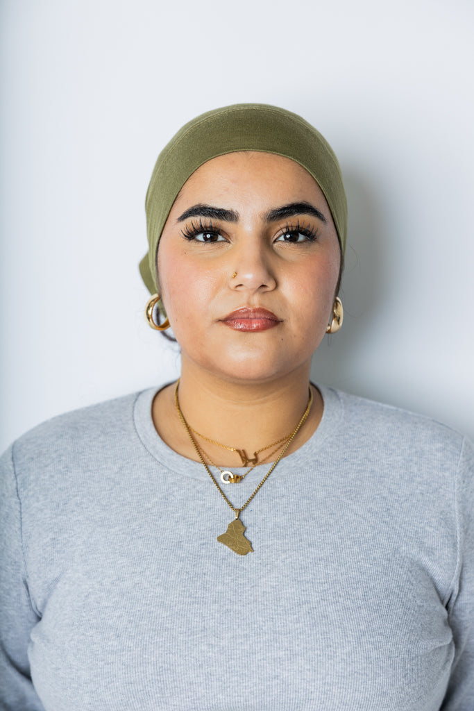 woman wearing an olive green under scarf tube cap for hijab