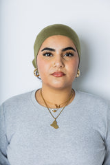 woman wearing an olive green under scarf tube cap for hijab