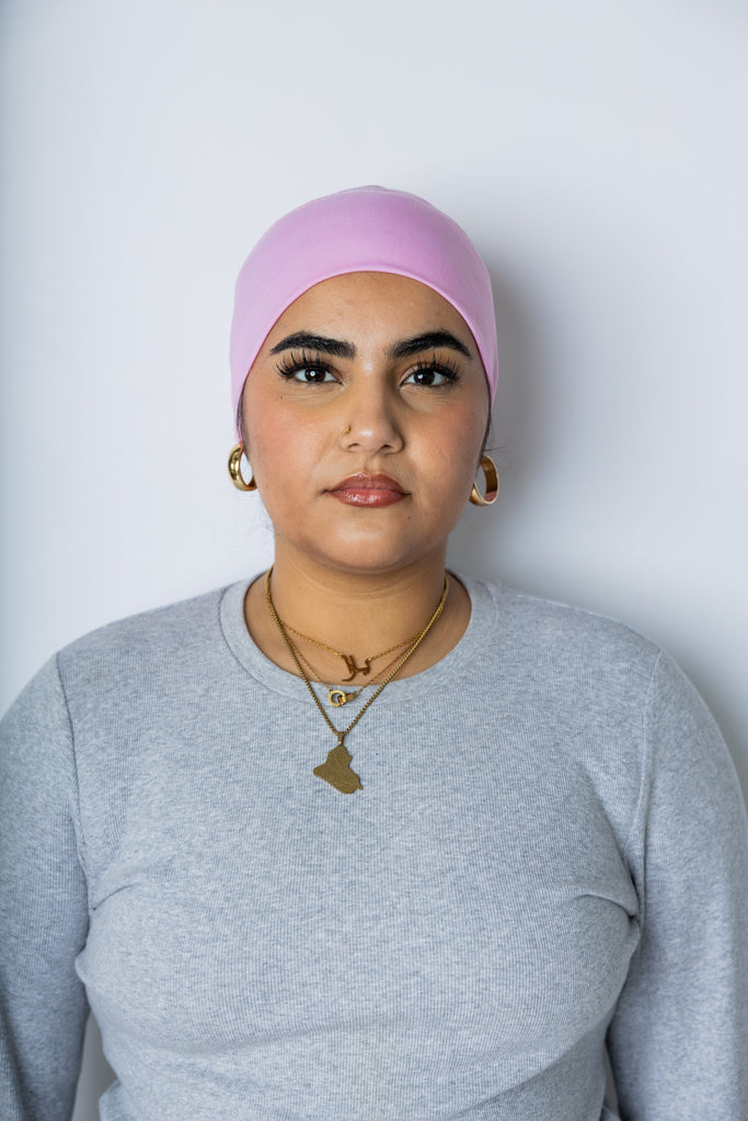 woman wearing a light pink under scarf tube cap for hijab