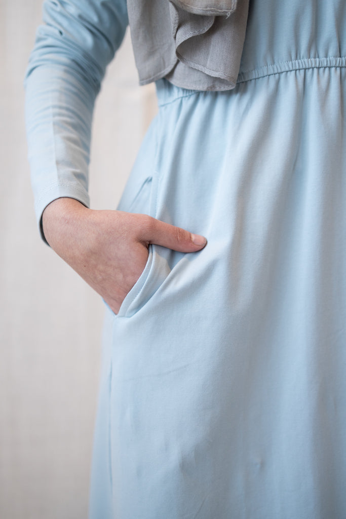 muslim woman in a light blue long sleeved maxi dress