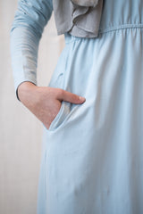 muslim woman in a light blue long sleeved maxi dress