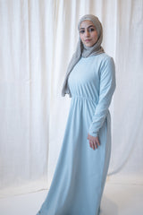 muslim woman in a light blue long sleeved maxi dress