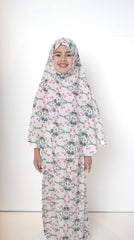 two piece salah outfit with hijab and skirt printed with pink, green, and white floral