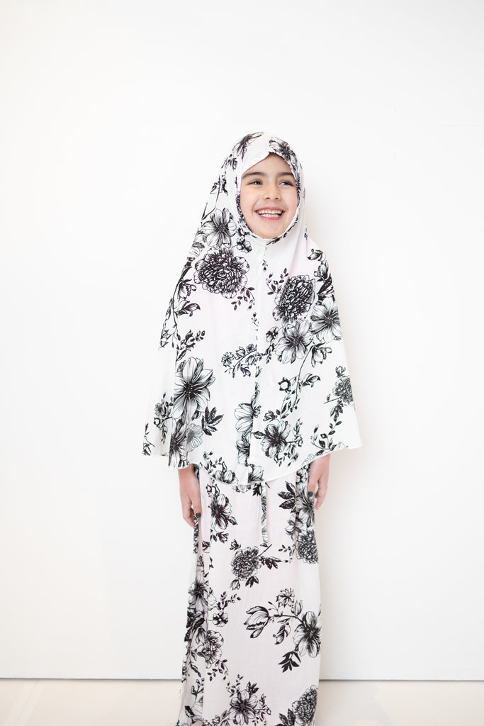 two piece salah outfit with hijab and skirt printed with black and white floral