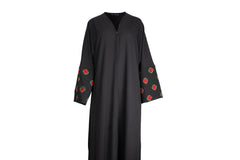 a black abaya with button clasps and pockets and watermelon and poppy tatreez palestinian embroidery along the sleeves