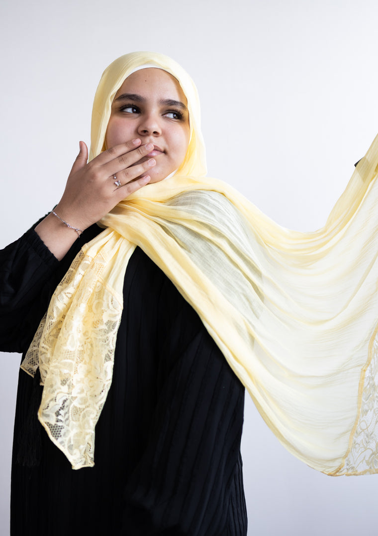 solid light yellow hijab made with modal fabric and embellished with lace at the ends