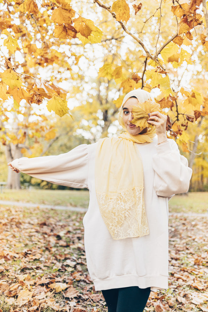 solid light yellow hijab made with modal fabric and embellished with lace at the ends