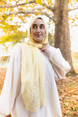 solid light yellow hijab made with modal fabric and embellished with lace at the ends 