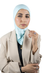 muslim woman wearing a beige blazer and baby blue ninja underscarf