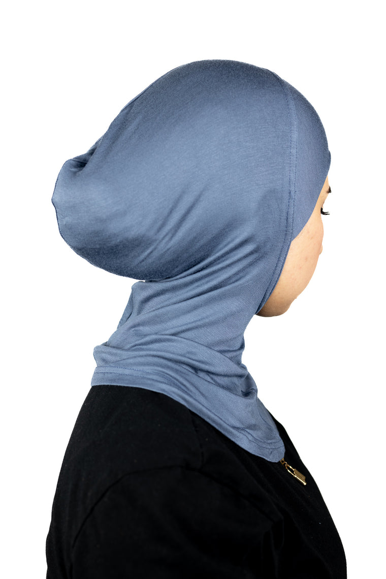 muslim woman wearing a beige blazer and night sky blue ninja underscarf