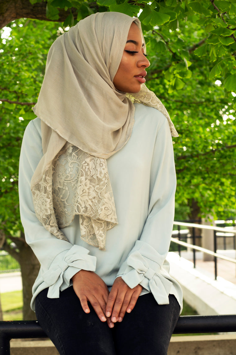 solid gray hijab made with modal fabric and embellished with lace at the ends