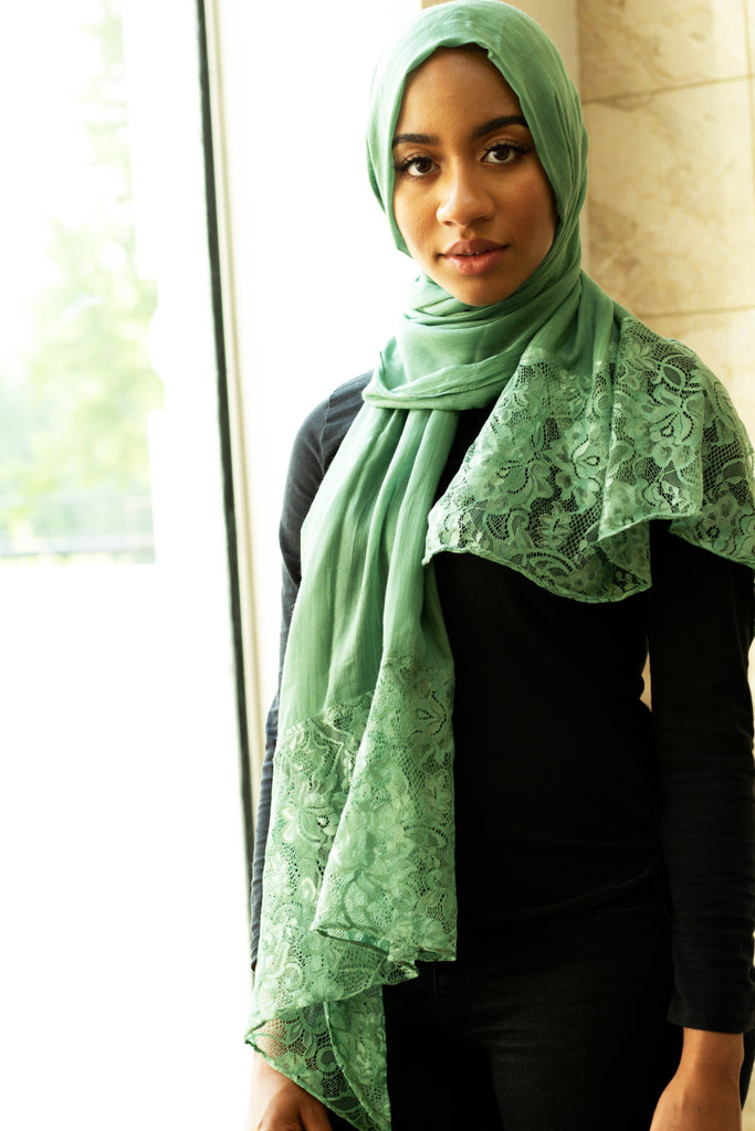 solid light green hijab made with modal fabric and embellished with lace at the ends