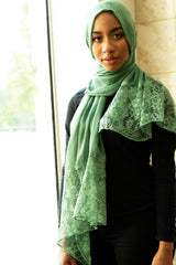 solid light green hijab made with modal fabric and embellished with lace at the ends