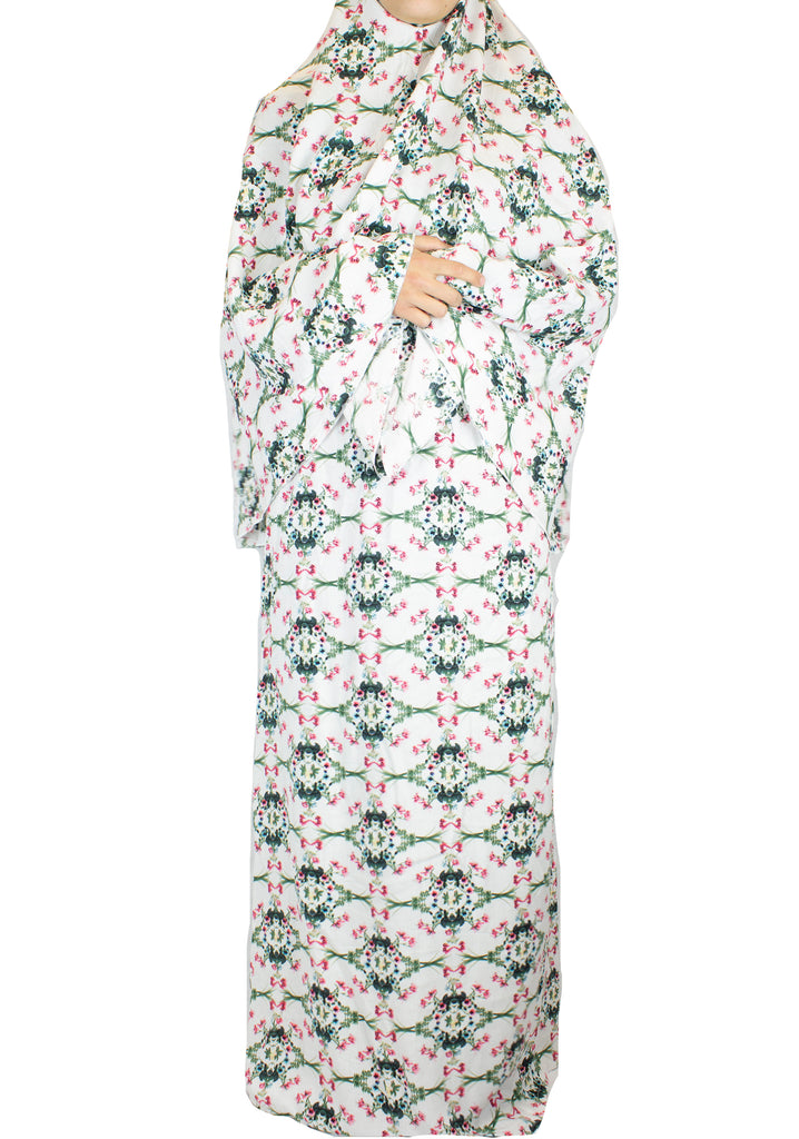 two piece salah outfit with hijab and skirt printed with pink, green, and white floral