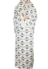 two piece salah outfit with hijab and skirt printed with pink, green, and white floral