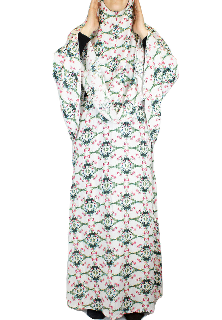 two piece salah outfit with hijab and skirt printed with pink, green, and white floral