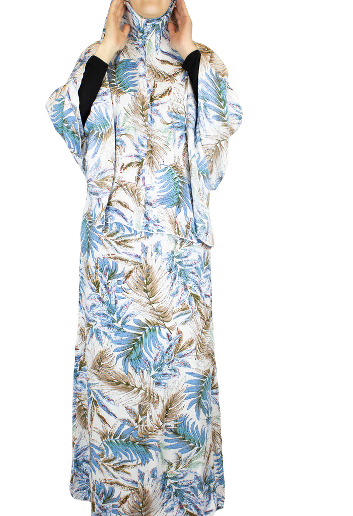 two piece salah outfit with hijab and skirt printed with blue, white, and beige leaves