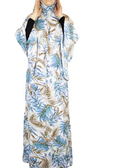 two piece salah outfit with hijab and skirt printed with blue, white, and beige leaves