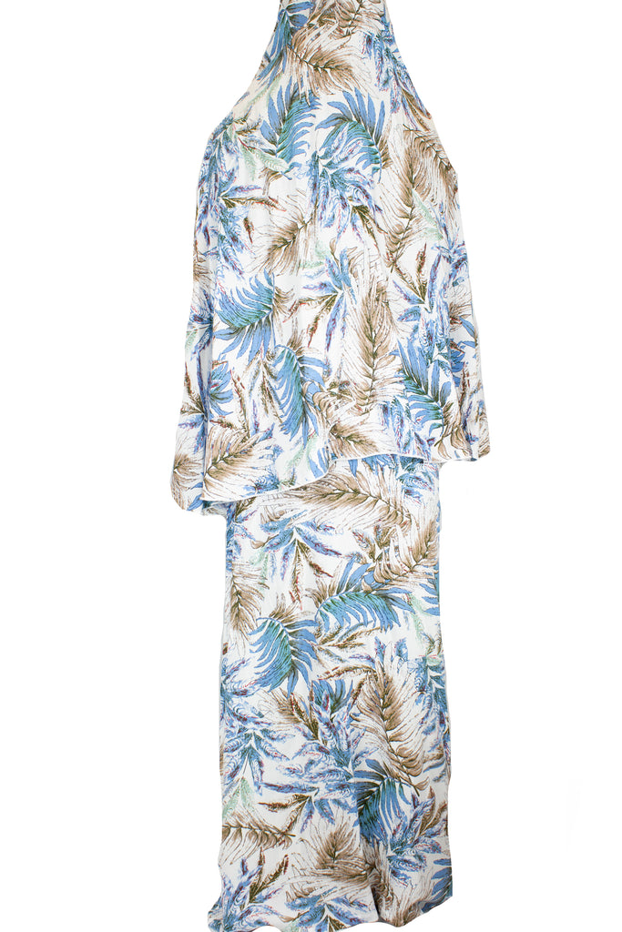 two piece salah outfit with hijab and skirt printed with blue, white, and beige leaves