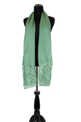 solid light green hijab made with modal fabric and embellished with lace at the ends