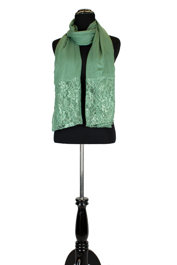 solid light green hijab made with modal fabric and embellished with lace at the ends
