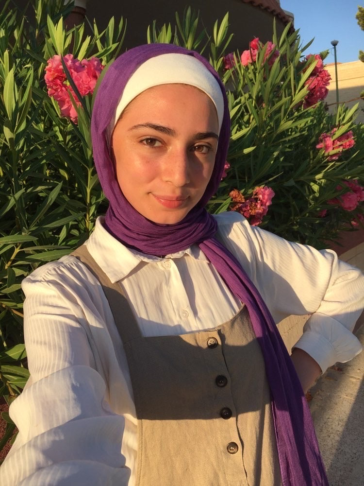 muslim woman wearing apurple modal hijab with a beige loungewear set