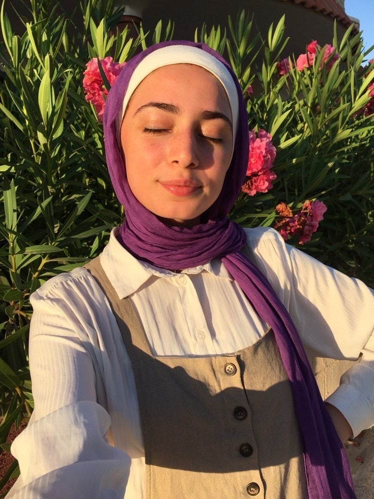 muslim woman wearing apurple modal hijab with a beige loungewear set