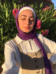 muslim woman wearing apurple modal hijab with a beige loungewear set