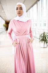muslim woman wearing a criss cross pink long sleeve elegant maxi dress with a white chiffon hijab