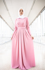 muslim woman wearing a criss cross pink long sleeve elegant maxi dress with a white chiffon hijab