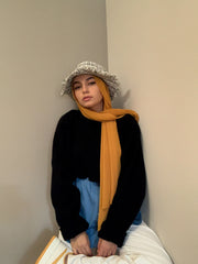 muslim hijabi woman wearing sunflower yellow chiffon hijab and denim button down shirt extension