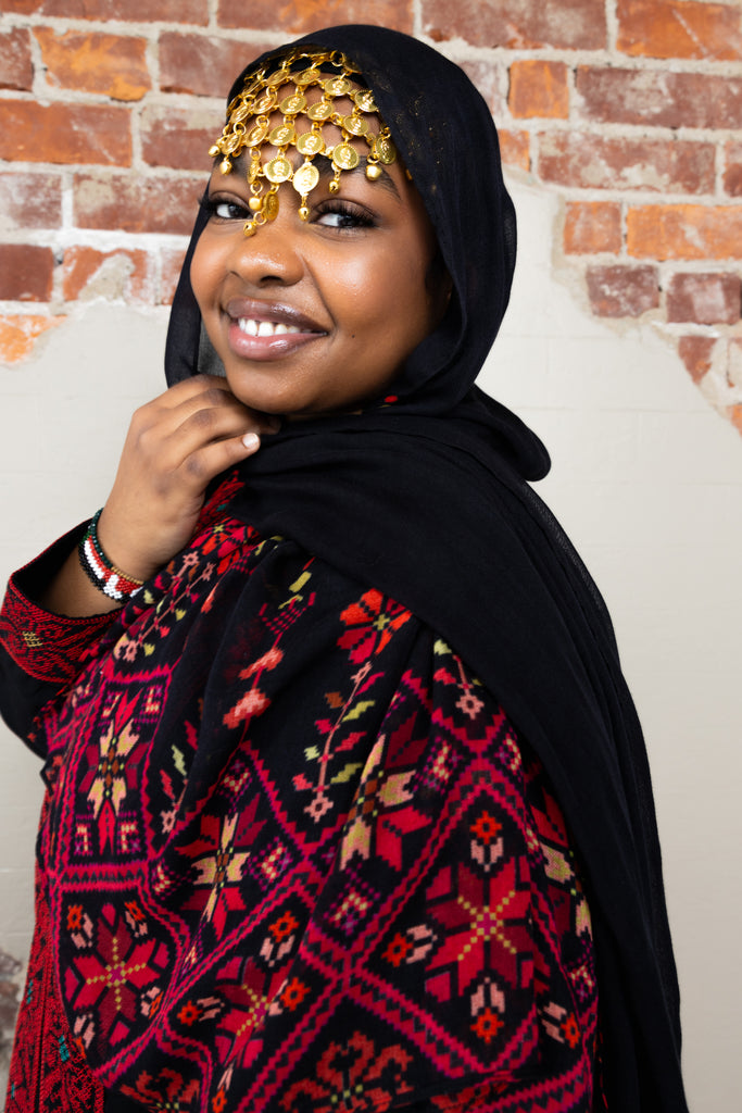 woman wearing black modal print hijab with tatreez Palestinian design 