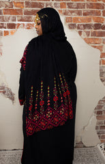 woman wearing black modal print hijab with tatreez Palestinian design 