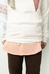 light pink shirt extender in jersey material layered with Palestine sweater