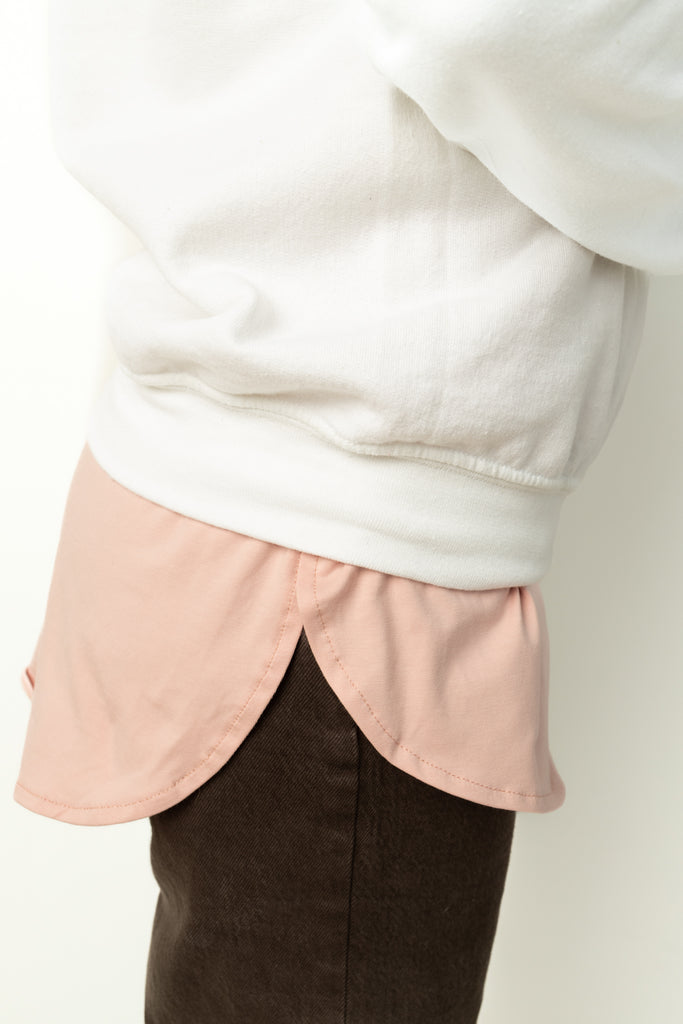 light pink shirt extender in jersey material layered with Palestine sweater