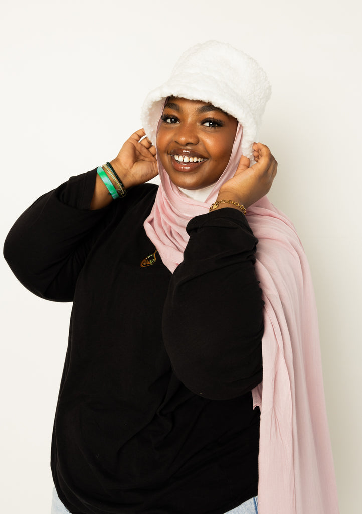 woman wearing modal hijab in different sizes in a light pink shade 