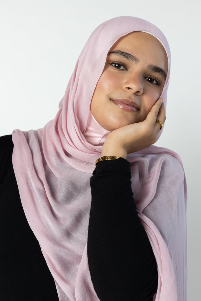 woman wearing modal hijab in different sizes in a light pink shade 