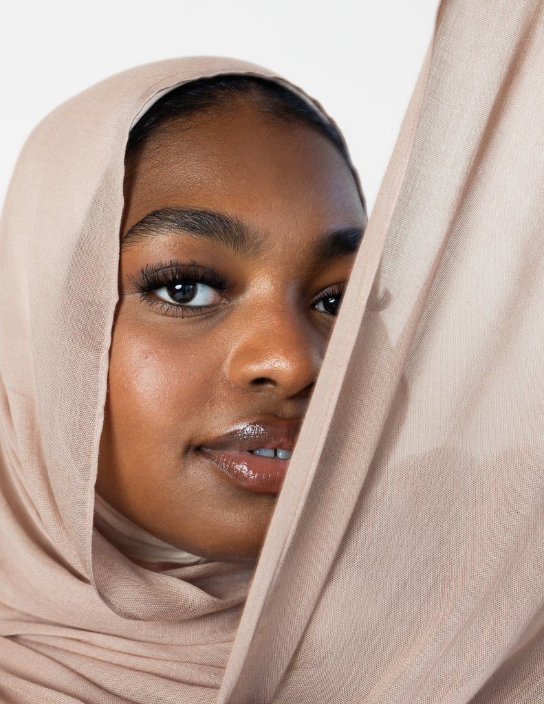 woman wearing modal hijab in different sizes in a truffle mushroom light sand stone tan shade 