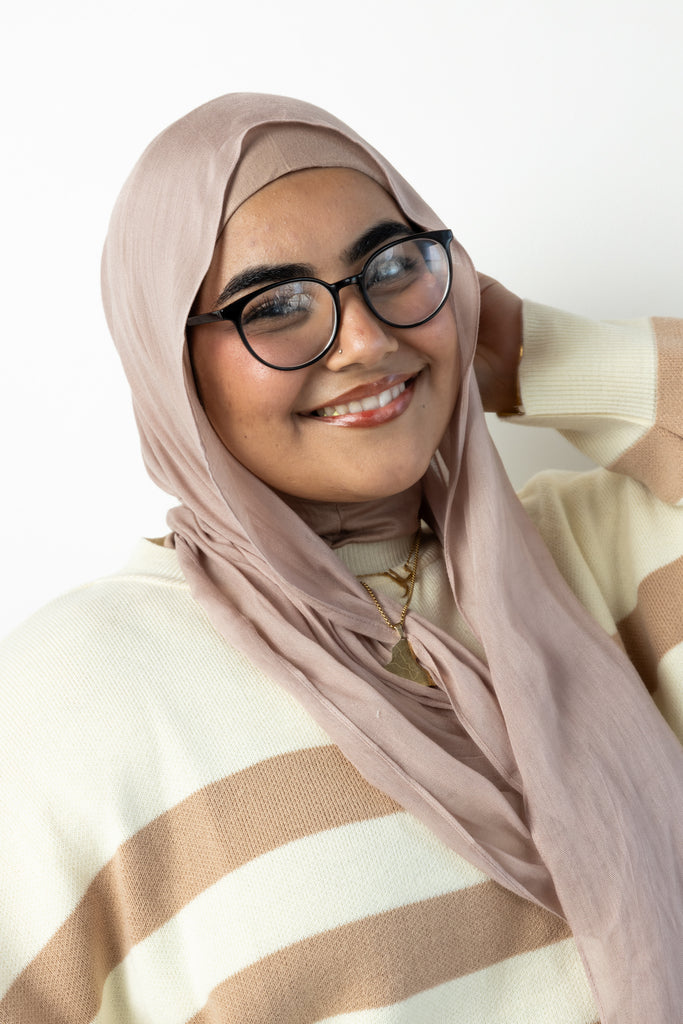 woman wearing modal hijab in different sizes in a truffle mushroom light sand stone tan shade wearing glasses with hijab and sweater fall outfit