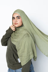 woman wearing modal hijab in different sizes in an olive green tone 