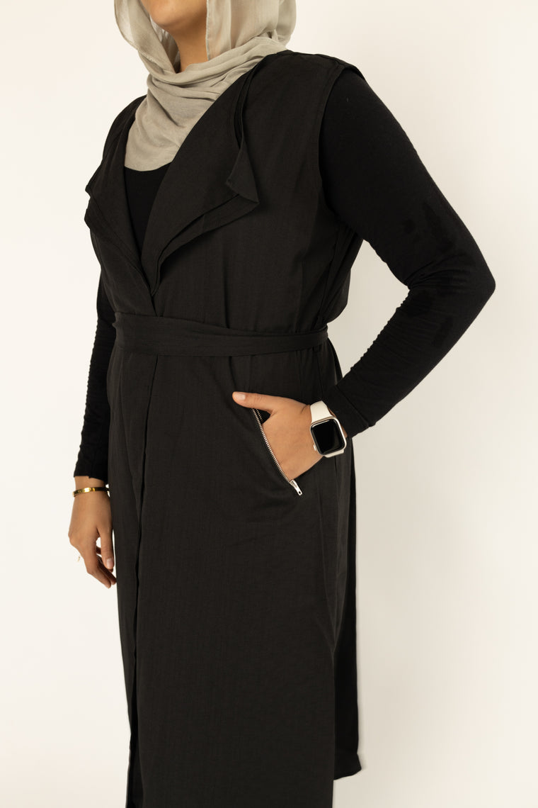 black cascade sleeveless vest with a waist belt and pockets