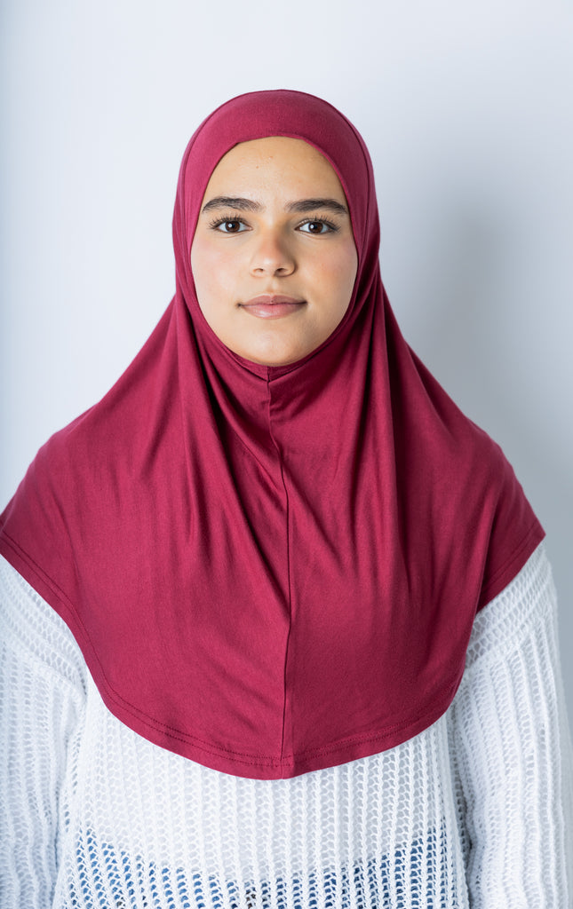 woman wearing a maroon jersey slip on one piece hijab